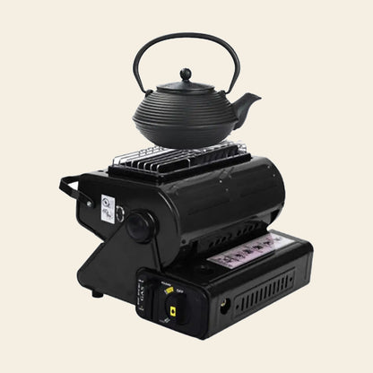 Portable butane gas heater and camp stove in black with a cast iron kettle sitting on its cooking ring