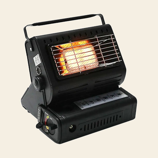 Portable gas heater alight, with the ceramic burner panel glowing orange behind the grille
